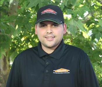 male crew member wearing black shirt and hat