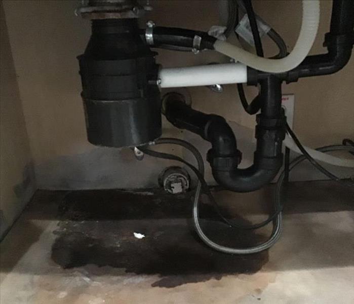 black piping under wooden cabinet, water pipe leak, pipe break near me, restoration services edh near by
