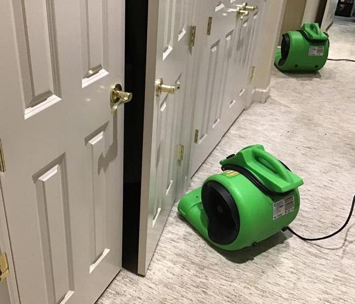 3 green air mover machines drying the wet hallway from water damage in shingle springs