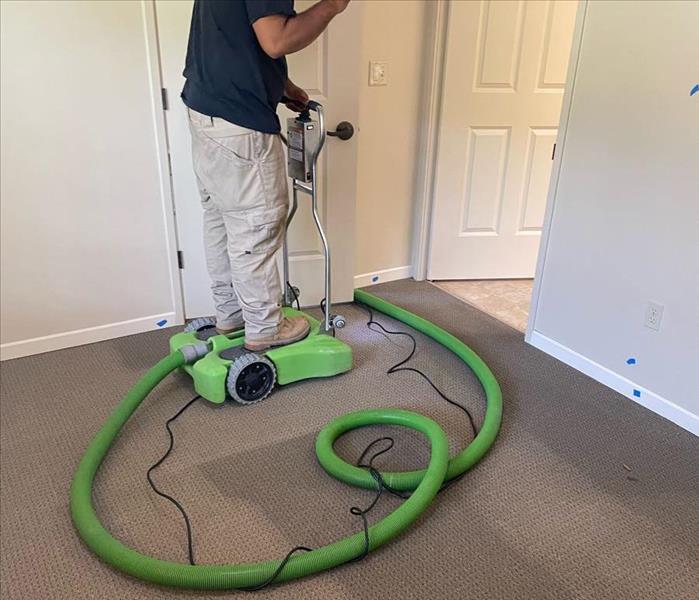 technician using water vacuum