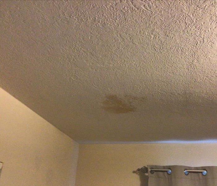 brown staining patch on white drywall ceiling from water damage in sacramento
