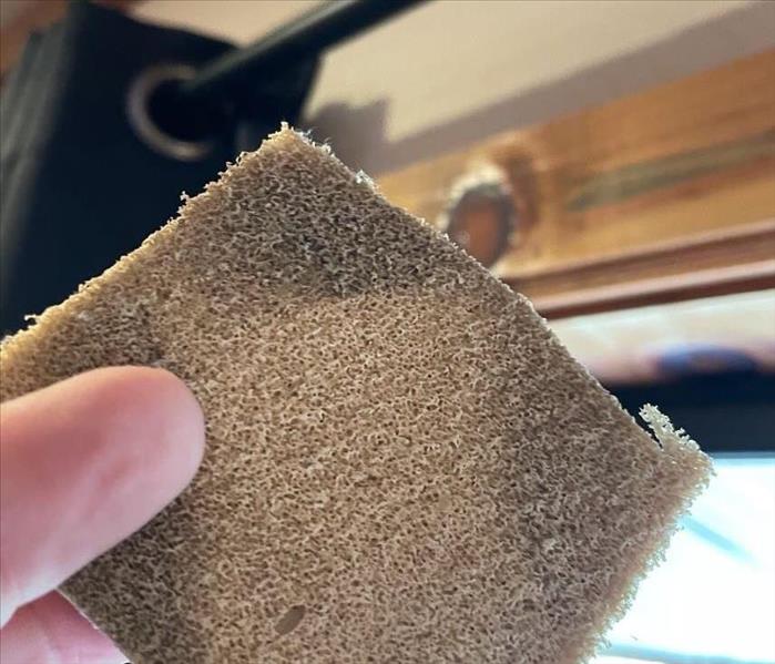 chemical sponge with darkened corners from soot damage and smoke damage