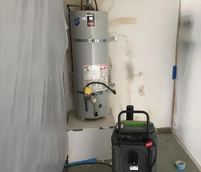 water heater in open space with green equipment